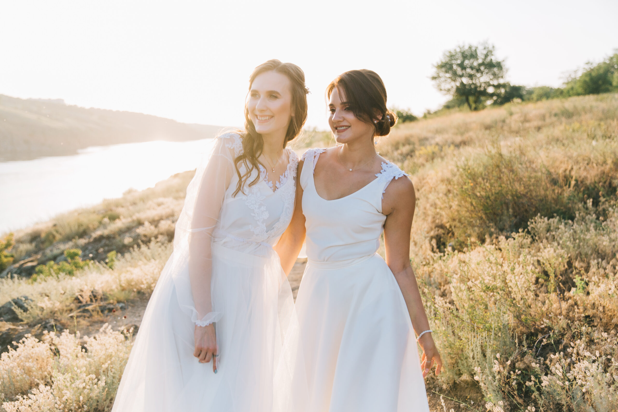 women in white dresses in field